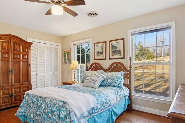 bedroom with ceiling fan, a closet, and hardwood / wood-style flooring