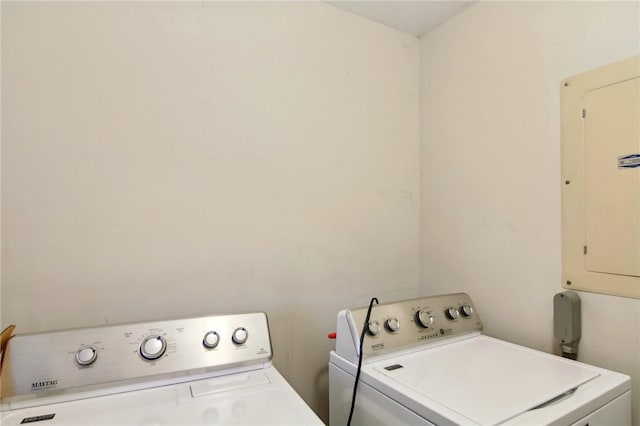 laundry area with washing machine and clothes dryer and electric panel