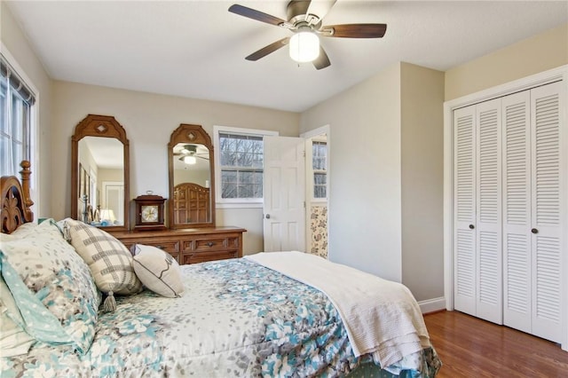 bedroom with ceiling fan, a closet, and dark hardwood / wood-style floors