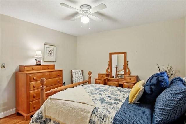 bedroom with ceiling fan and wood-type flooring