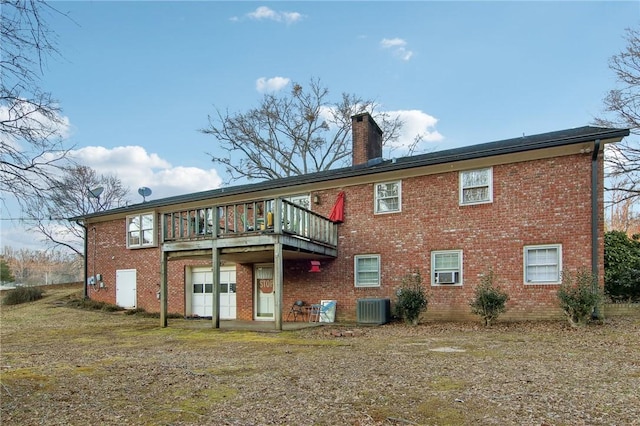 rear view of property featuring a deck, central air condition unit, and cooling unit