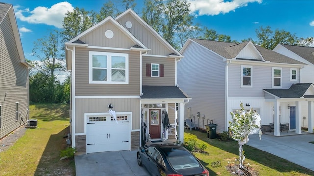 view of front facade featuring a front yard, central AC unit, and a garage