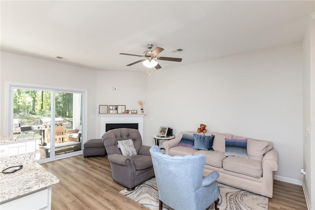 living room featuring ceiling fan and light wood-type flooring