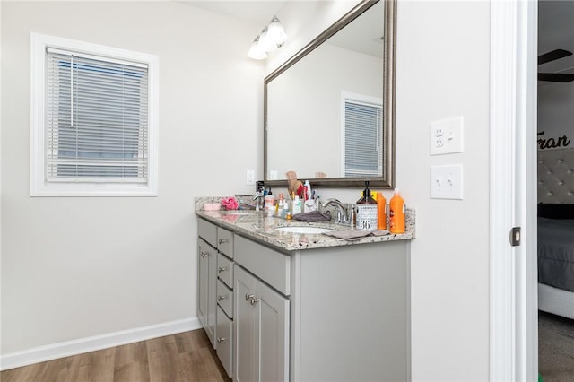 bathroom featuring ceiling fan, vanity, and hardwood / wood-style flooring