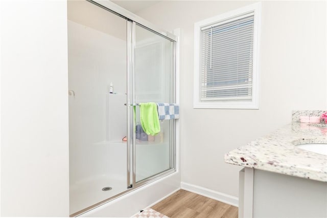 bathroom featuring vanity, hardwood / wood-style floors, and walk in shower