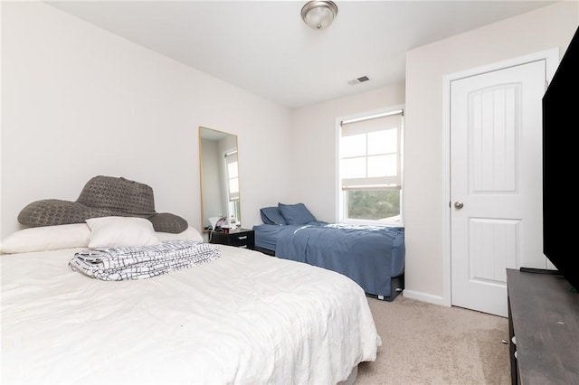 bedroom featuring light carpet