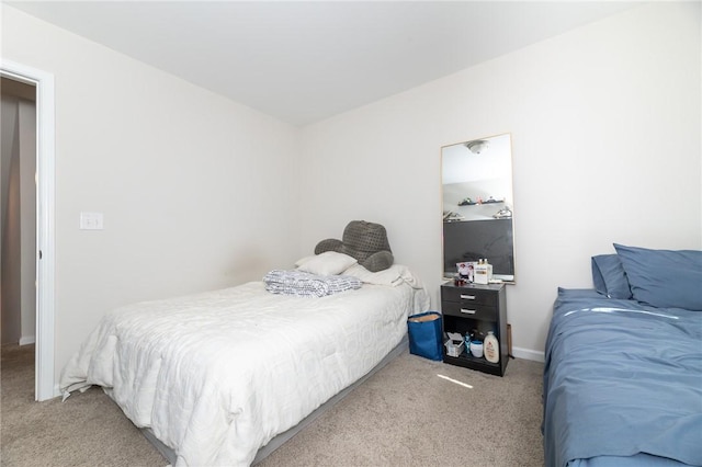 bedroom featuring light carpet