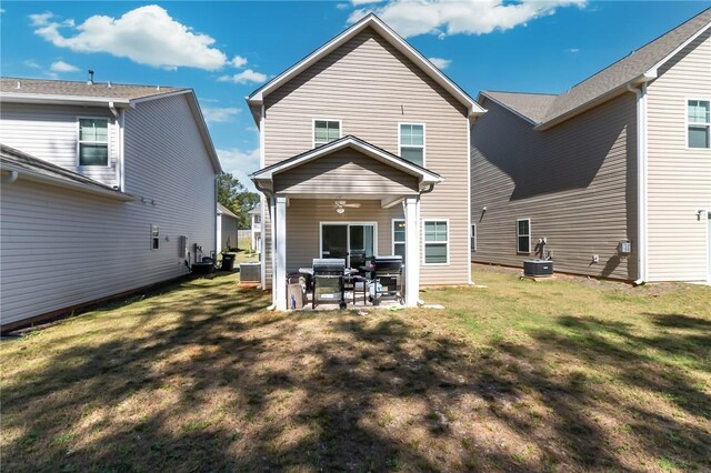 rear view of property featuring a lawn and a patio