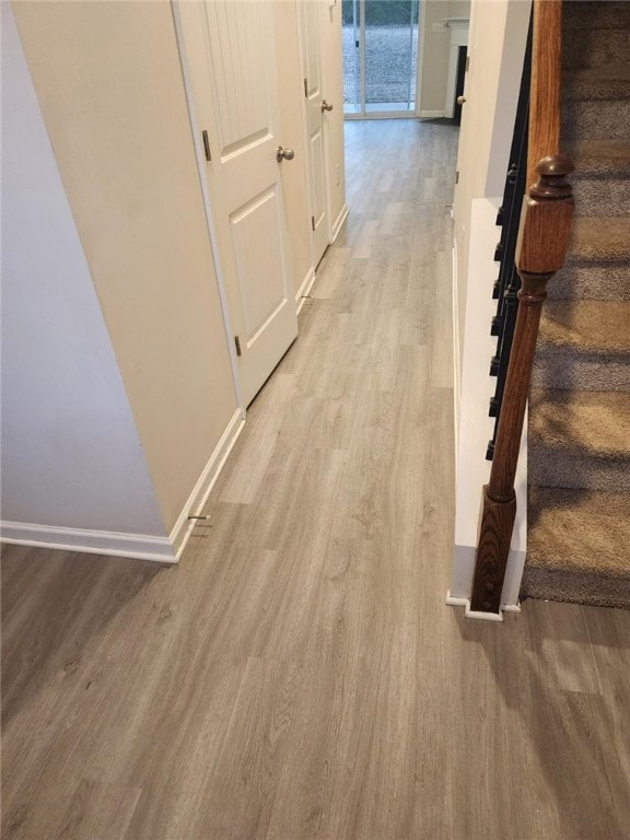 hallway with light wood-type flooring