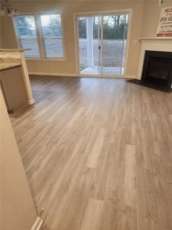 unfurnished living room with light hardwood / wood-style floors