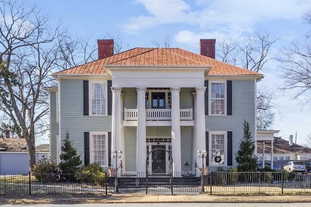 greek revival inspired property with a balcony