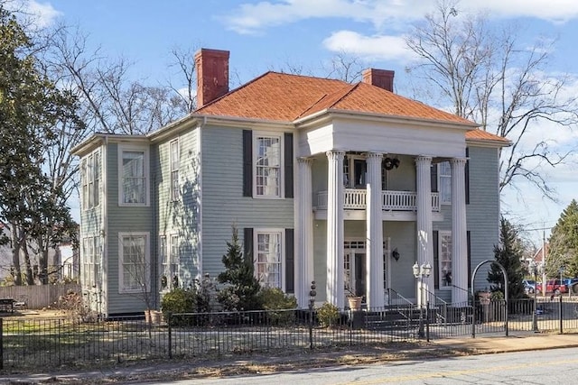 greek revival house featuring a balcony