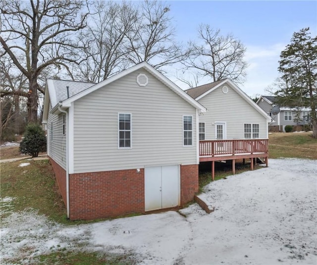 back of property featuring a wooden deck