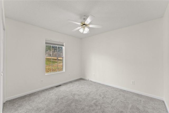 empty room with ceiling fan and carpet flooring