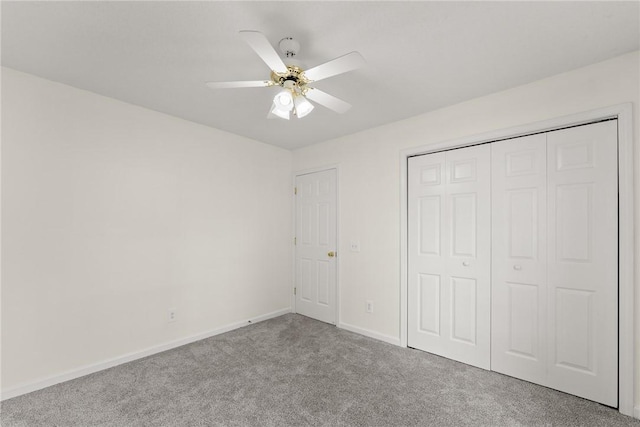 unfurnished bedroom with ceiling fan, light carpet, and a closet