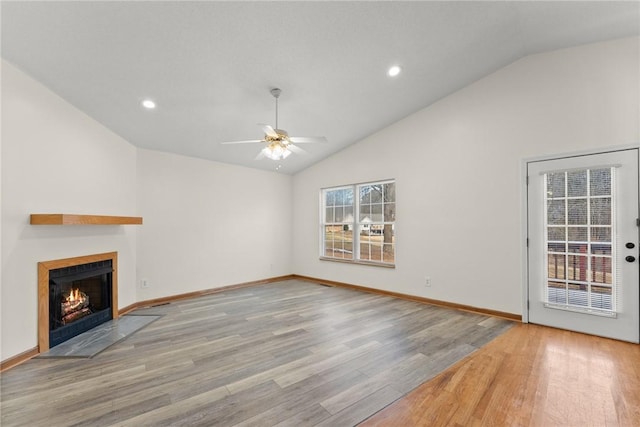 unfurnished living room featuring light wood-type flooring, ceiling fan, and lofted ceiling