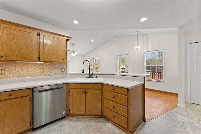 kitchen featuring kitchen peninsula, tasteful backsplash, dishwasher, vaulted ceiling, and sink