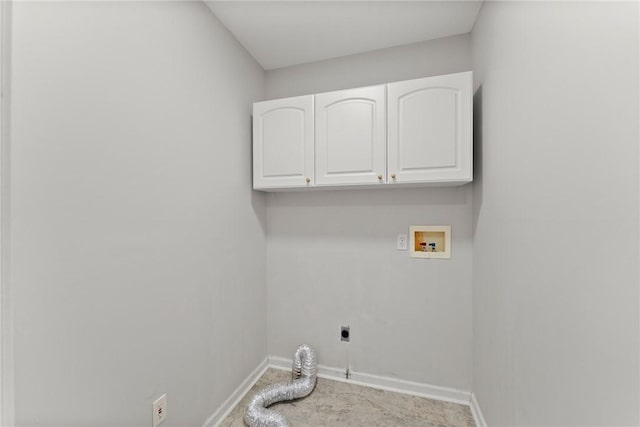 laundry area with hookup for an electric dryer, hookup for a washing machine, and cabinets