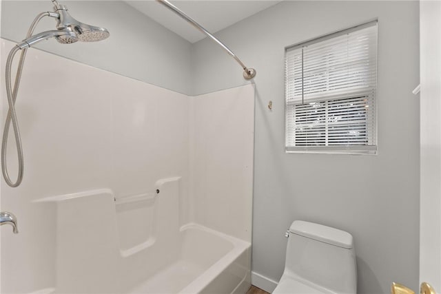 bathroom featuring toilet and shower / tub combination