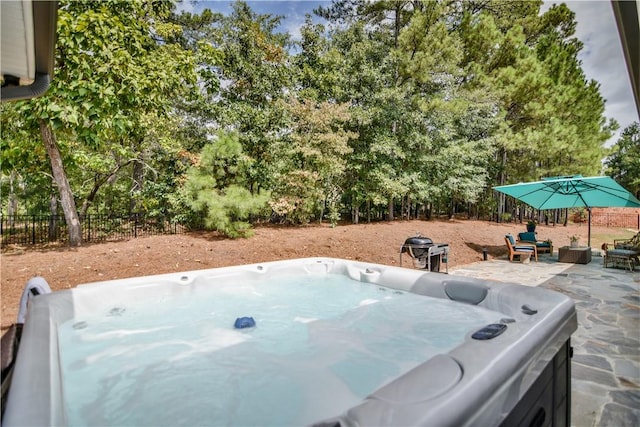 exterior space with a patio area and a hot tub