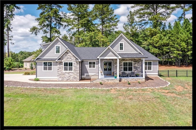 craftsman house with a front yard and a patio area