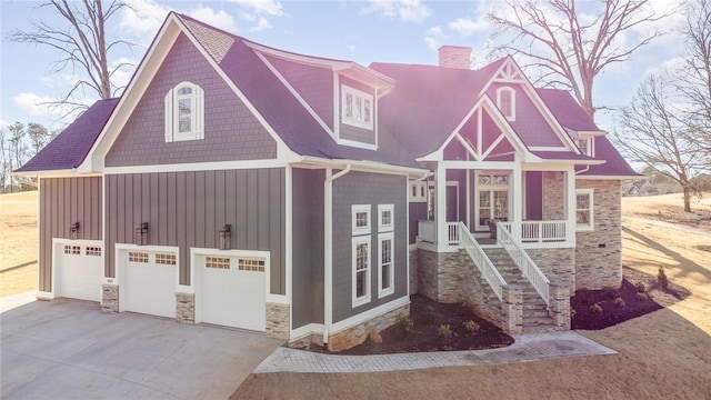 view of front of property with a porch and a garage