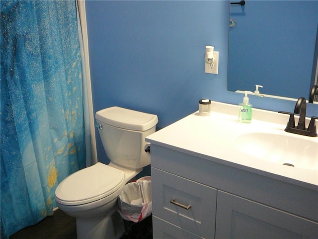 bathroom featuring toilet and vanity