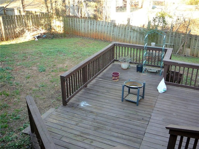 wooden terrace featuring an outdoor fire pit and a yard