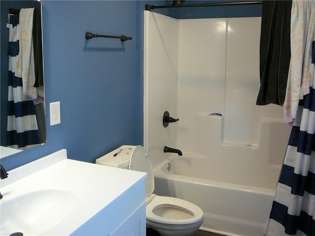 full bathroom with toilet, shower / tub combo with curtain, and sink