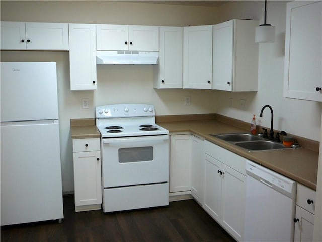 kitchen with under cabinet range hood, dark wood finished floors, white cabinets, white appliances, and a sink