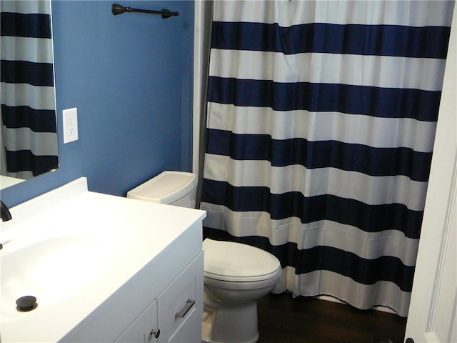 bathroom featuring vanity, wood finished floors, toilet, and a shower with curtain