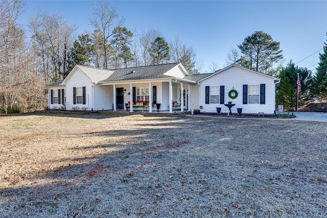 single story home featuring a porch and a front yard