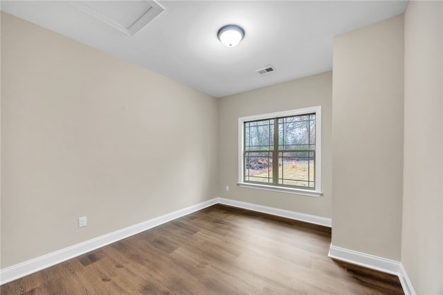 spare room with dark wood-type flooring