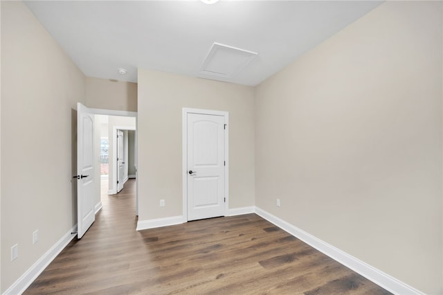 unfurnished bedroom with dark hardwood / wood-style floors