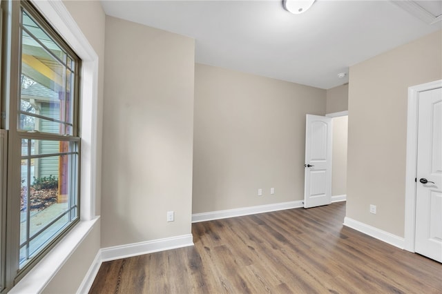 empty room with dark hardwood / wood-style flooring