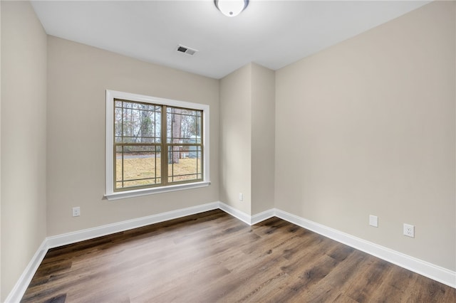 spare room featuring dark hardwood / wood-style flooring