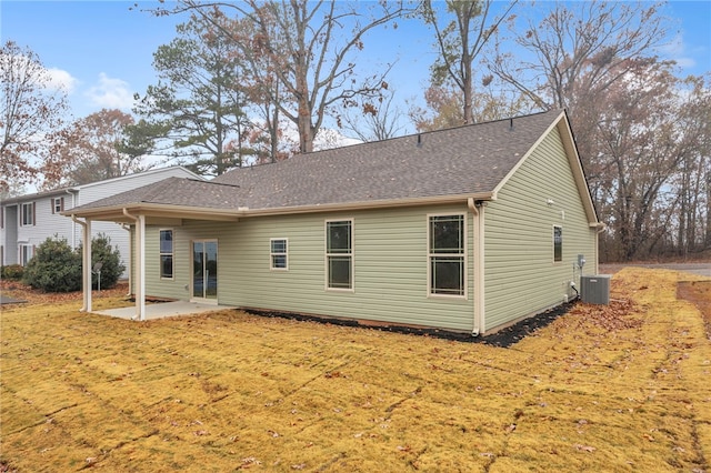 back of property featuring cooling unit, a yard, and a patio