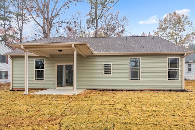 back of house with a yard and a patio