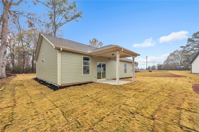 back of house featuring a patio area and a yard