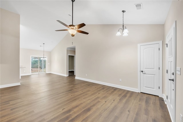 interior space featuring vaulted ceiling, dark wood-type flooring, and ceiling fan with notable chandelier