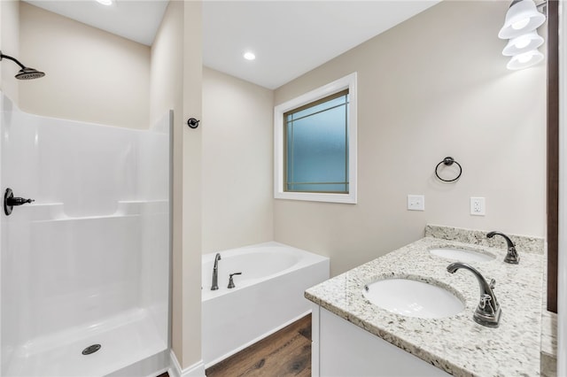 bathroom with vanity, wood-type flooring, and plus walk in shower