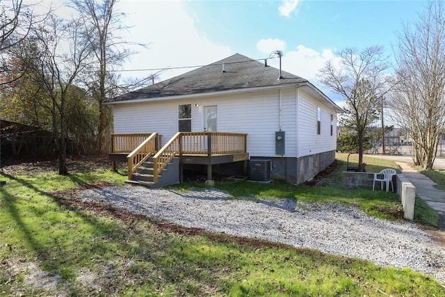 rear view of house with central AC and a wooden deck