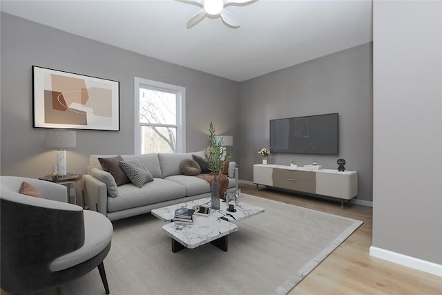 living room featuring ceiling fan and light hardwood / wood-style flooring