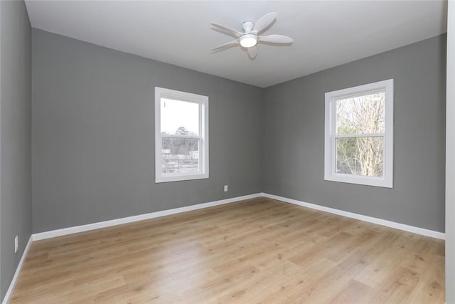 spare room featuring ceiling fan, plenty of natural light, and light hardwood / wood-style flooring