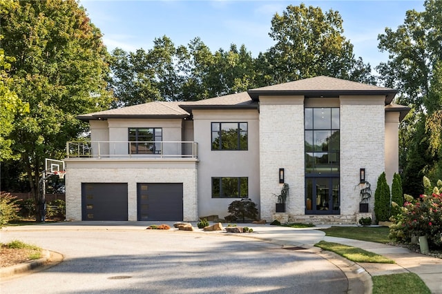 view of front of house with a garage and a balcony