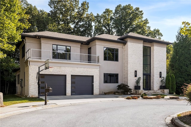 view of front of home with a balcony and a garage