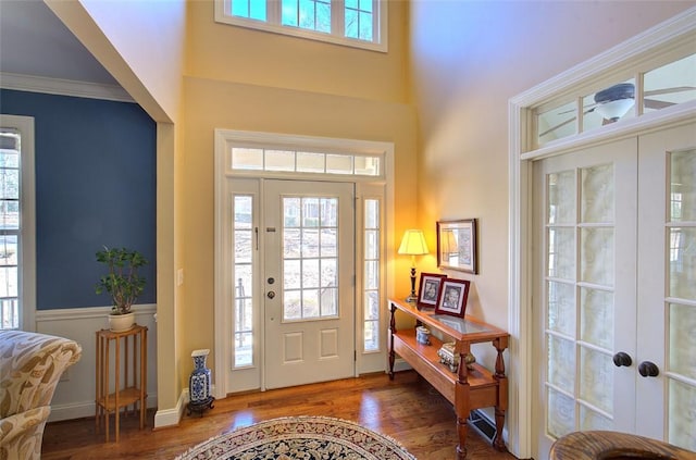 foyer featuring french doors, dark hardwood / wood-style flooring, and ornamental molding