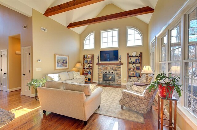 living room with a fireplace, wood-type flooring, and high vaulted ceiling