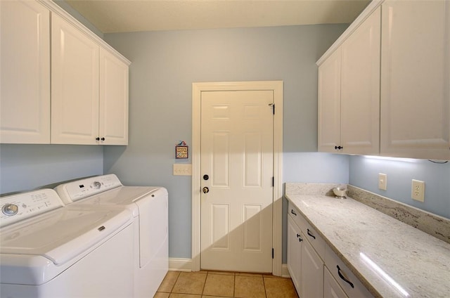 laundry room featuring light tile patterned floors, independent washer and dryer, and cabinets