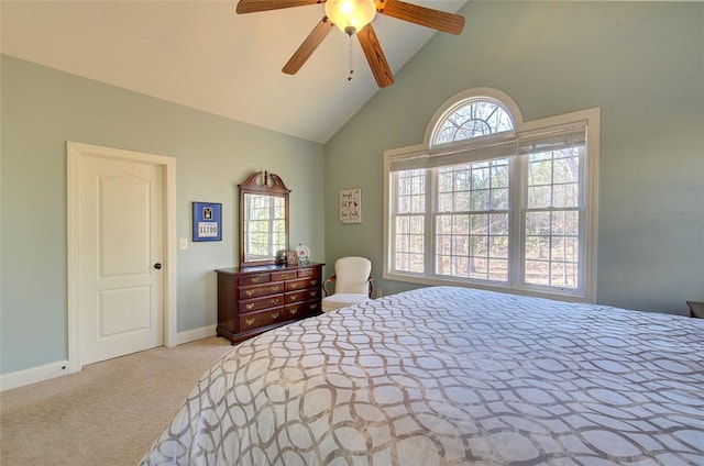 carpeted bedroom with ceiling fan, vaulted ceiling, and multiple windows